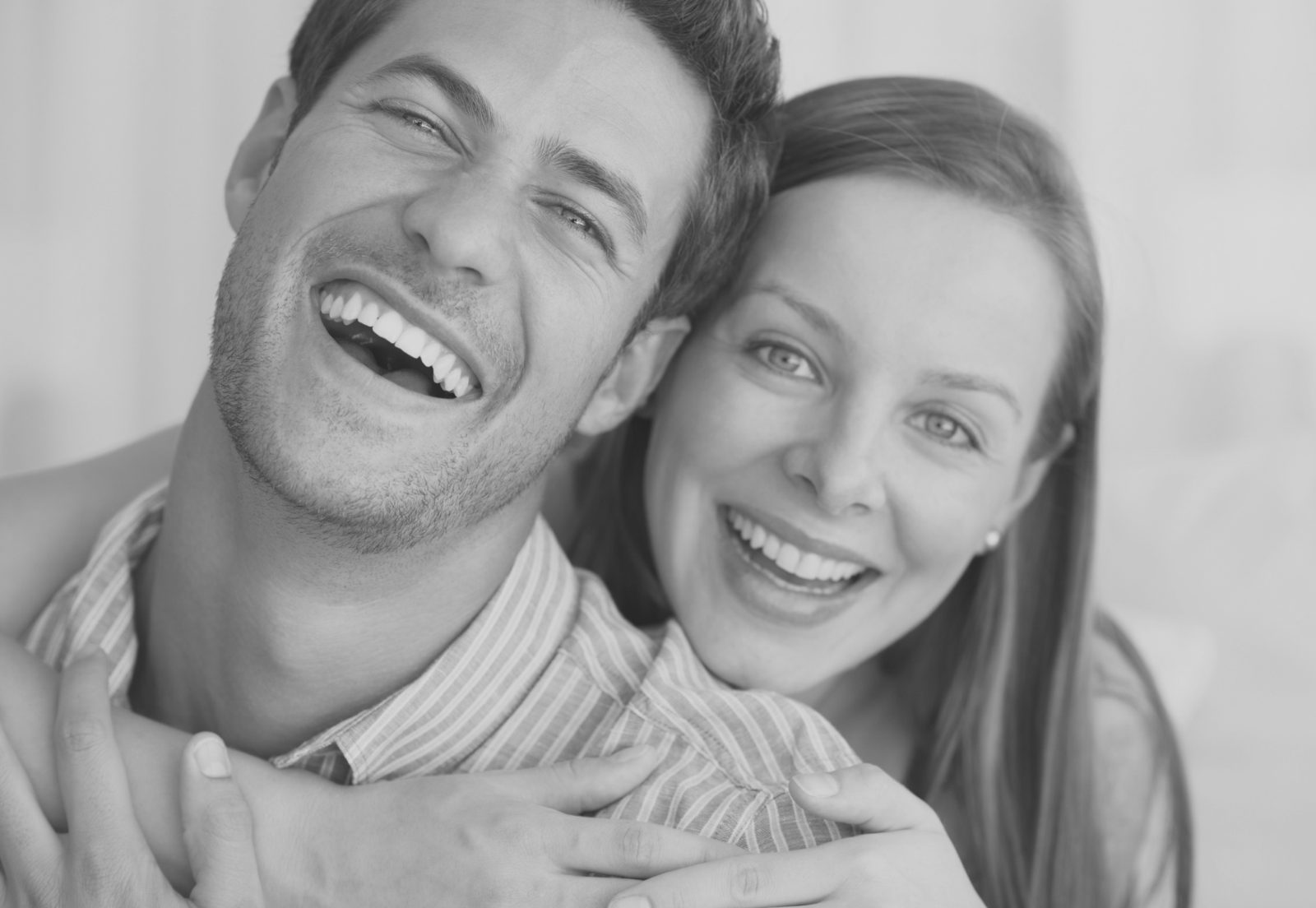 A couple laughing together, cheek to cheek
